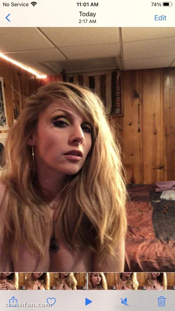 Close-up portrait of Nora Vines with long blonde hair indoors against wood-panelled walls