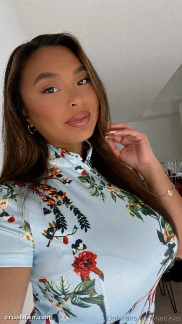 Linda Vo in a light blue floral top posing indoors for a close selfie